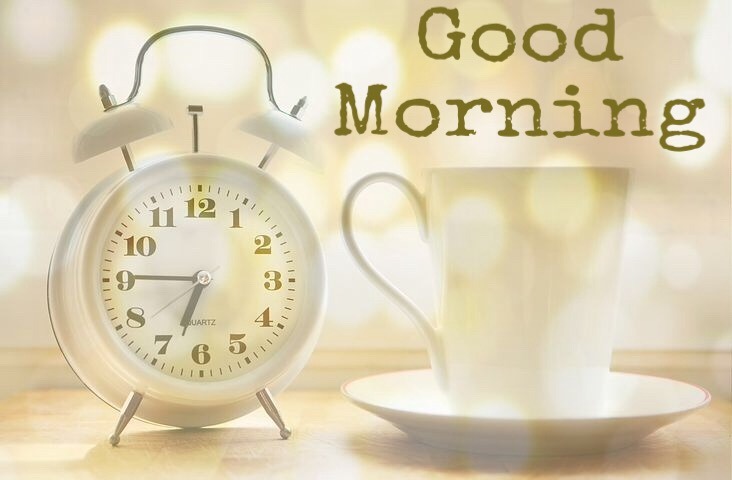 Good morning image with alarm clock and coffee cup 