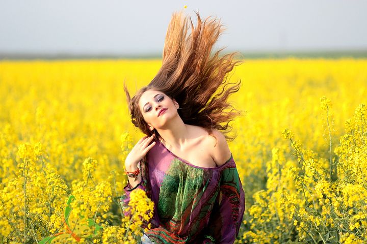 Beautiful girl in yellow flowers farm image 